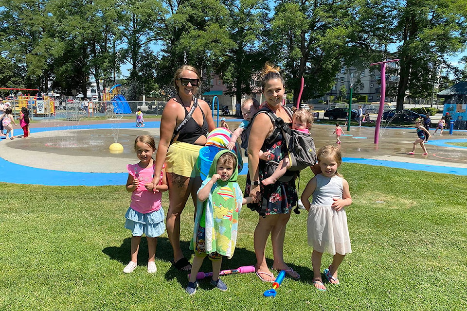Jana Wooding (left) and her daughter joined friend Jaime Friesen with her four children at Douglas Park to cool off at the spray park on Thursday, June 24, 2021. (Joti Grewal/Langley Advance Times)