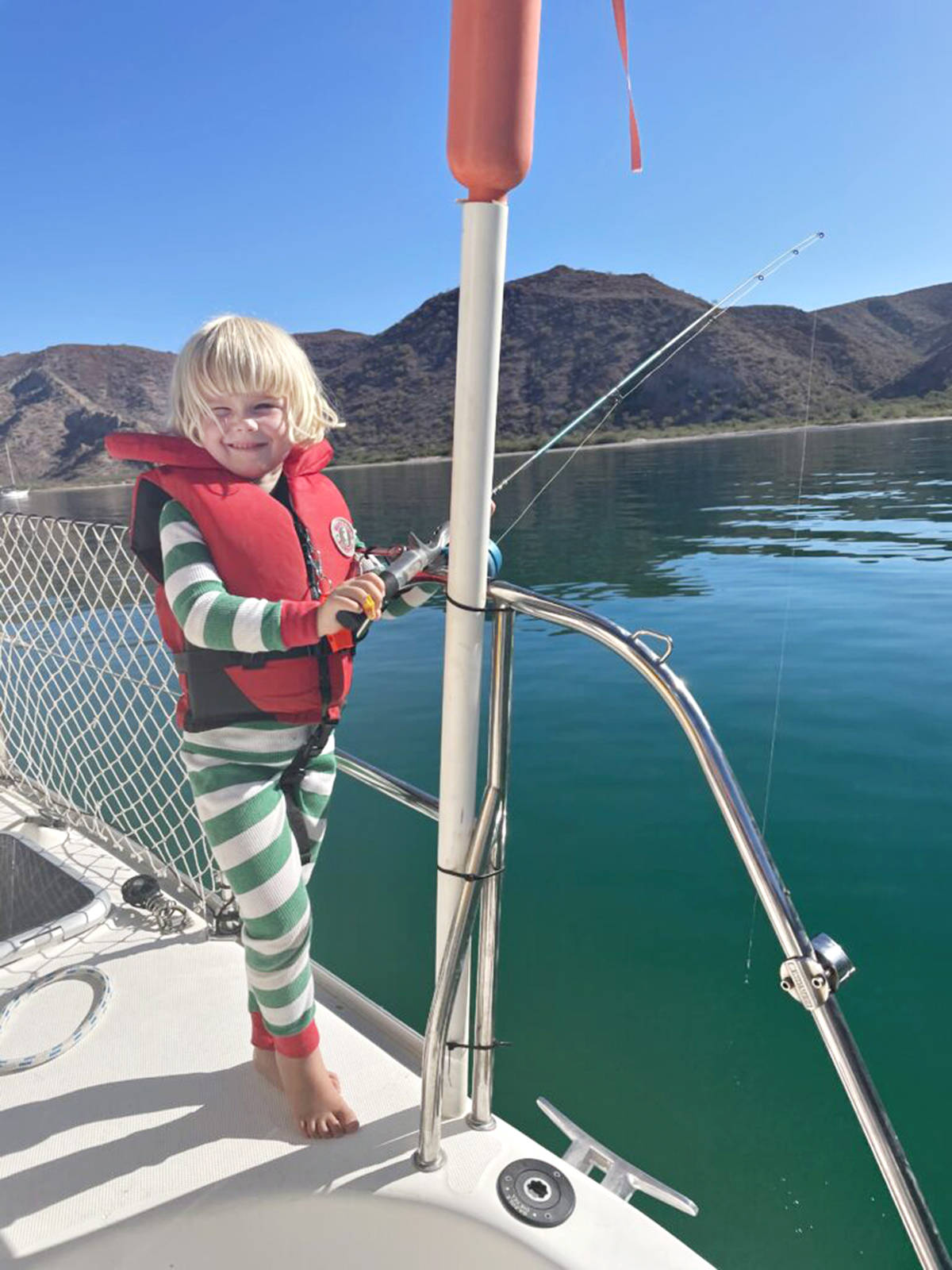 Ellie goes fishing from the Skookum V. 黑马磁力 lawyer Erin Easingwood, husband Stu, and their kids have gone sailing full-time. (www.skookumsailing.ca/Special to 黑马磁力 Advance times)