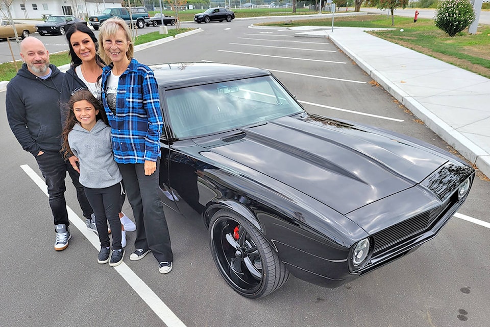 Murrayville resident Susan Simning has been organizing car-oriented fundraisers in memory of her son, Bradley McPherson, who was murdered in 2011. Before the Sunday, Aug. 22 ‘Burnouts in the sky’ event, Simning (right), posed with her daughter, Jennie McPherson (centre), son-in-law Robin Dodd and Jennie’s eight-year-old daughter Bradleigh Wynnyk-McPherson, who is named after her late uncle. (Dan Ferguson/91ԭ Advance Times)