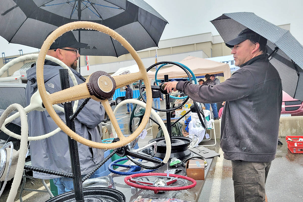Clay Grant (right) from North Delta discussed price for one of his antique steering wheels as the Good Times Cruise-In swap meet and car corral got underway in the parking lot of the Aldergrove Community Secondary School at 26850 29th Avenue on Sunday morning, Sept. 12. (Dan Ferguson/91ԭ Advance Times)
