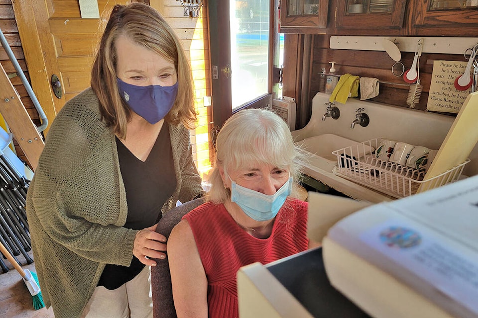 Petrina Arnason (left) with volunteer Teresa Spring, read a decades-old article about her mother then-alderman Muriel Arnason on Saturday, Sept. 25, at the Alder Grove Heritage Society museum, as part of Community Heritage Day. (Dan Ferguson/) (Dan Ferguson/)
