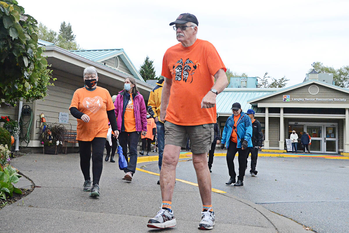 26671895_web1_210930-LAT-MC-OrangeShirtSeniorsWalk2