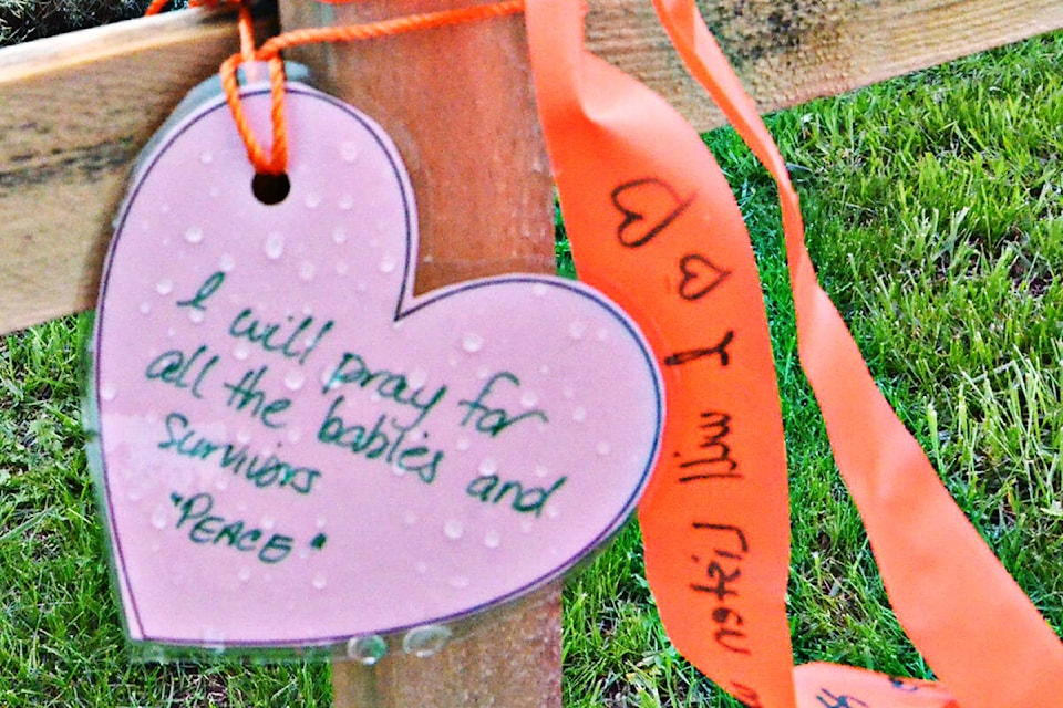People wrote messages on laminated hearts that were attached to wooden crosses at the Derek Doubleday Arboretum. (Heather Colpitts/Langley Advance Times)