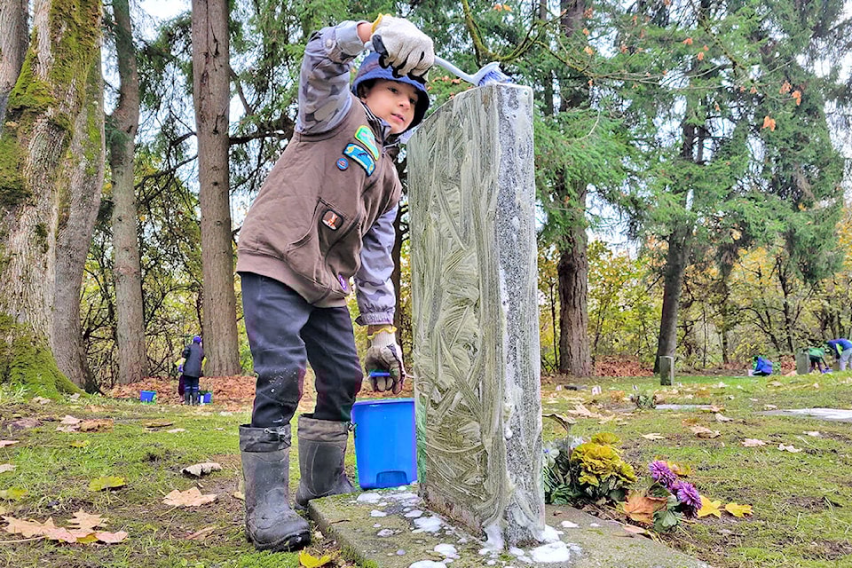 Scout Kadyn of the Second 91ԭ Mavericks scout group was cleaning veterans headstones at the Murrayville cemetery on Saturday, Nov. 6, to prepare for Remembrance Day. (Dan Ferguson/91ԭ Advance Times)