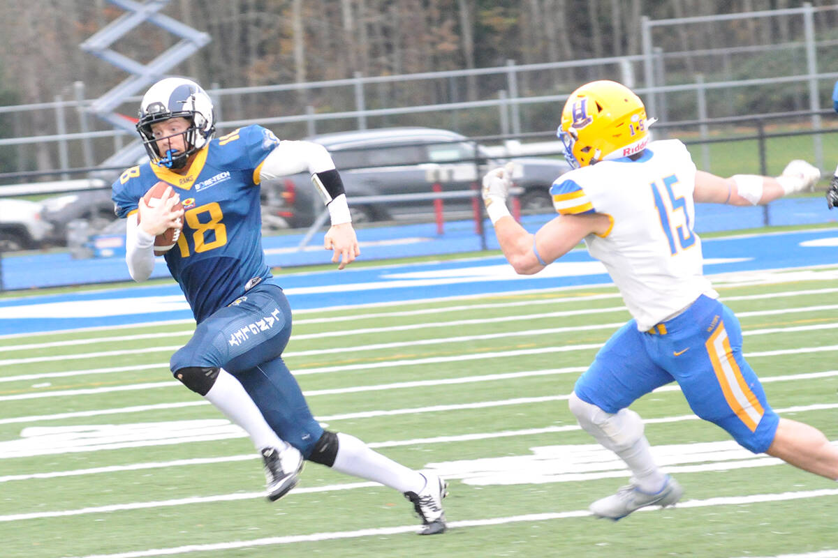 The Rams Michael Calvert fended off a Hilltops tackler as Langley downed Saskatoon 17-14 Saturday, Nov. 20 at McLeod stadium. (Dan Ferguson/Langley Advance Times)