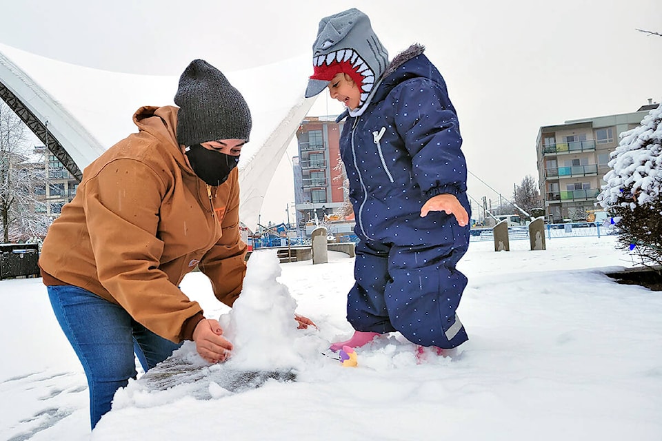 For Langley City resident Farah Alrubaye and daughter Dayana, 2, the Monday Dec. 6 weather was an opportunity to play in the snow at Douglas Park. (Dan Ferguson/Langley Advance Times)