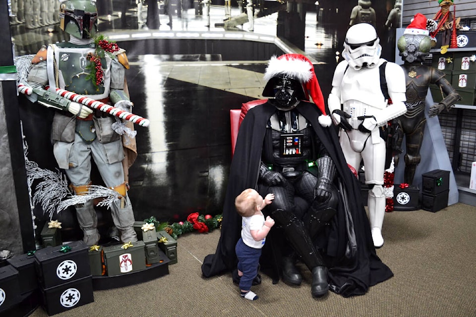 Children of all ages, as well as a few adults, recently lined up to have their photos taken with Santa Vader and the 501st Legion, a group who dress up in Star Wars costumes. (Special to Langley Advance Times)
