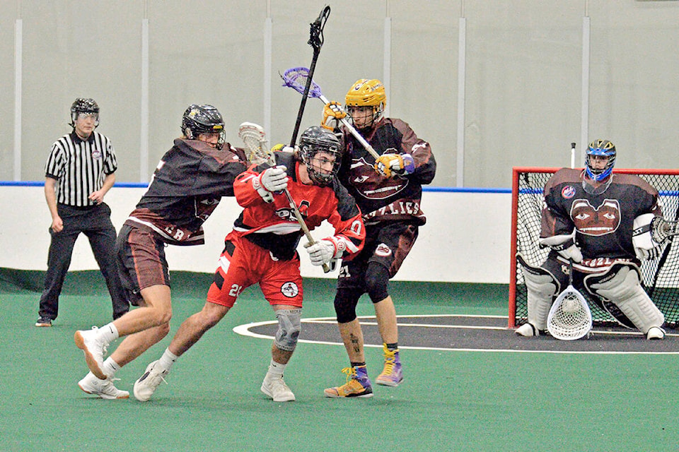 Black Fish player Jordan Roberts tangled with Grizzlies defenders Brayden Laity and Cody Garrison on the way to a 12-8 victory over the previously unbeaten Grizzlies on Saturday, Jan. 8 at the LEC. Gary Ahuja, Langley Events Centre/Special to Langley Advance Times)