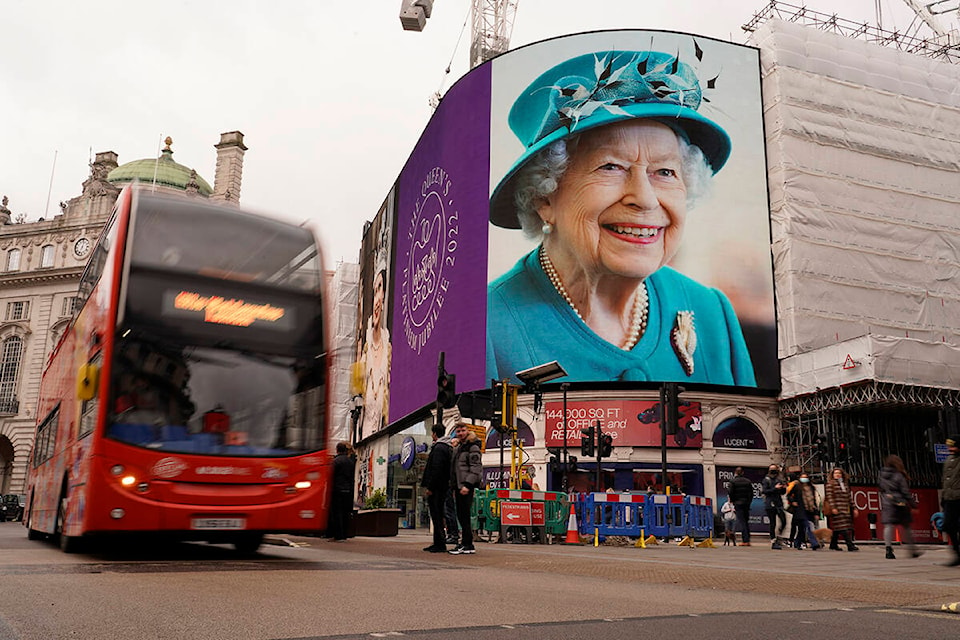 The screen in Piccadilly Circus is lit to celebrate the 70th anniversary of Britain’s Queen Elizabeth’s accession to the throne, in London, Sunday, Feb. 6, 2022.(AP Photo/Alberto Pezzali)