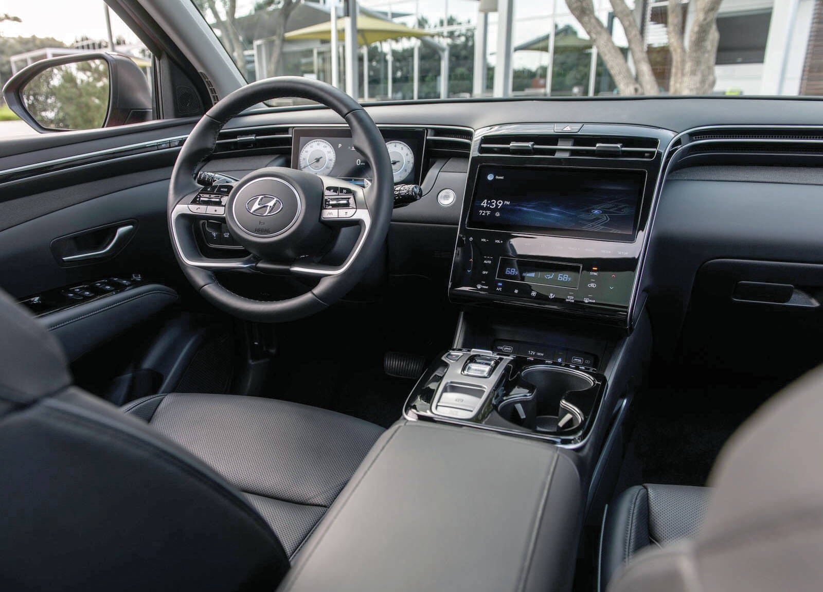 The 2022 Tucson聮s dash takes a whole new direction. There聮s a shiny interface, digital gauges popping out behind the steering wheel, and a small pad of buttons that replaces the traditional transmission shift lever. PHOTO: HYUNDAI
