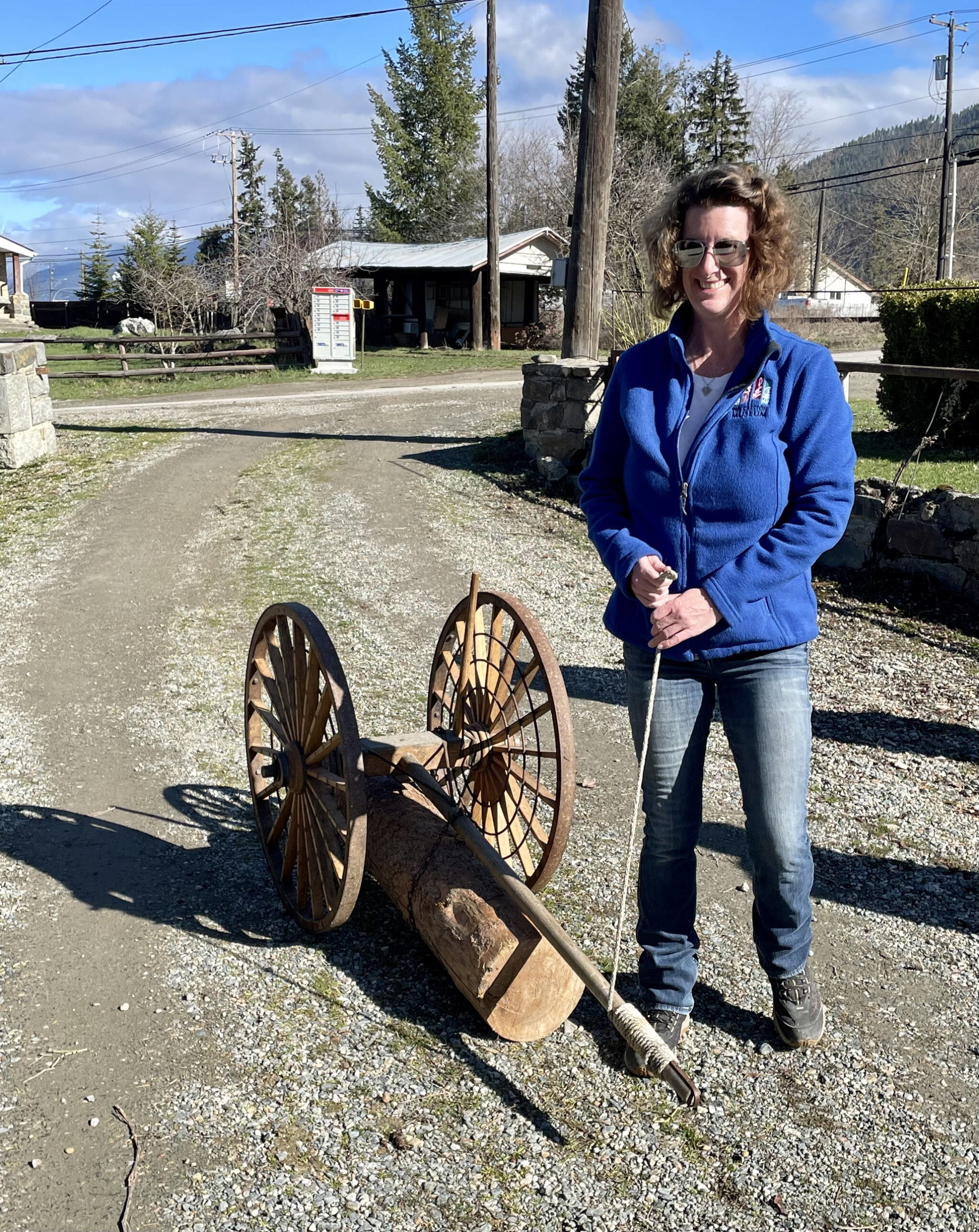 Tammy Bradford demonstrates how the logging arch was used on a miniature model. (Photo by Kelsey Yates)