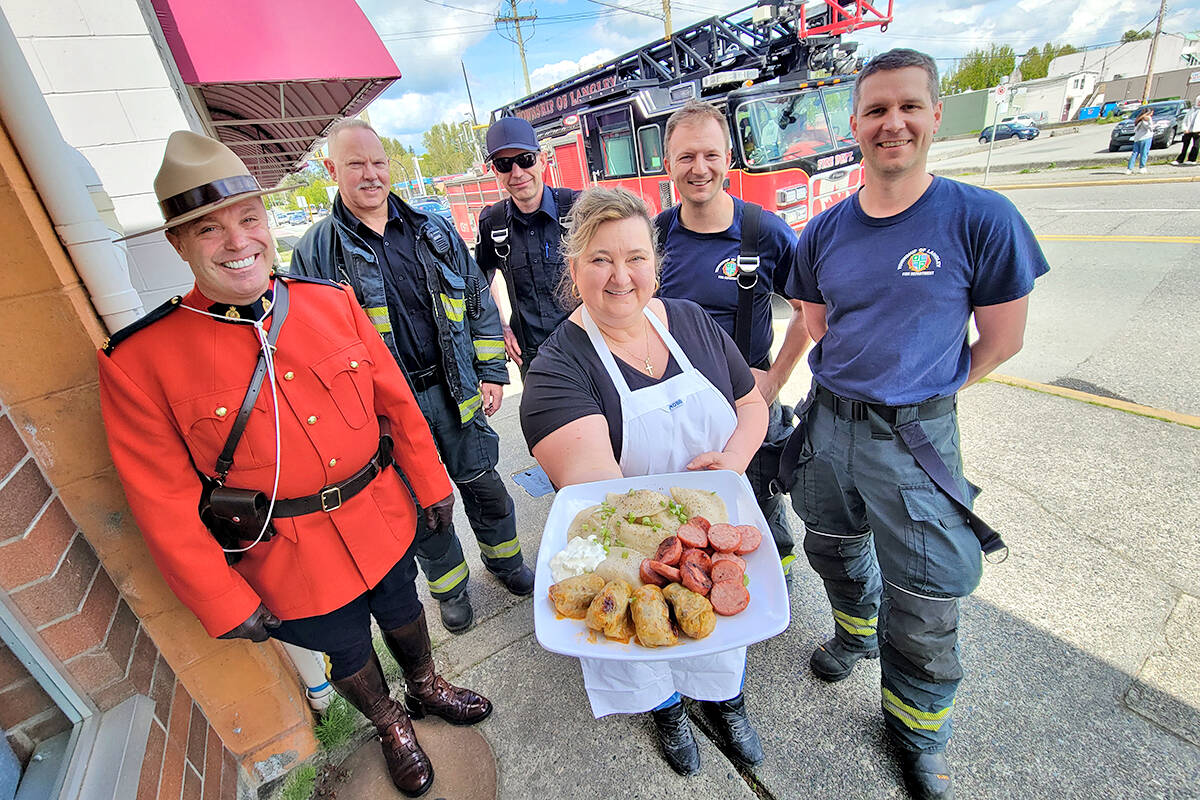 Aldergrove聮s Veronica Cave, of Veronica聮s Gourmet Perogies , was delighted with the response to a planned May 28 fundraising dinner for Ukraine. (left to right, behind Cave) Cst. Dennis Bell, Fire Captain Kim Pederson, and firefighters Jeremy Whitford, Ryan Olesko and Alastair Ohs. (Dan Ferguson/91原创 Advance Times)