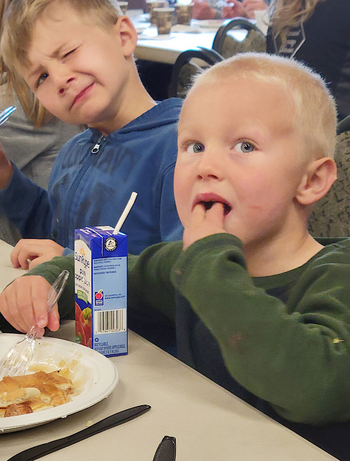 Alec, 4, one-handed his pancake at the Fort Seniors Halls breakfast event that preceded the May day Parade, while older brother Luke, 6, looked on disapprovingly. The siblings from the Merritt area were visiting grandparents.