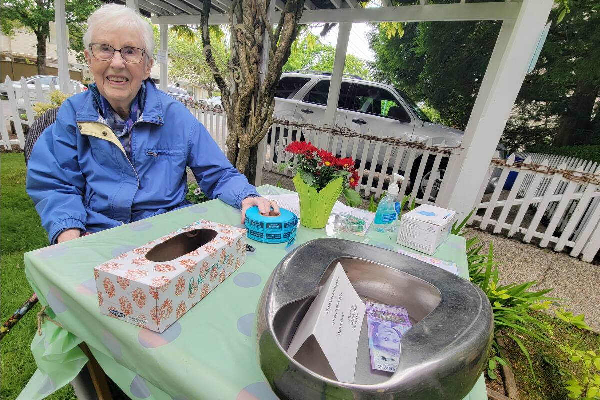 Langley author Doris Riedweg, a retired LMH nurse, was collecting contributions with a sanitized old-fashioned metal bedpan on Saturday, May 28 at Michaud House in Langley City during the Spring Tea event for retired medical professionals. (Dan Ferguson/Langley Advance Times)