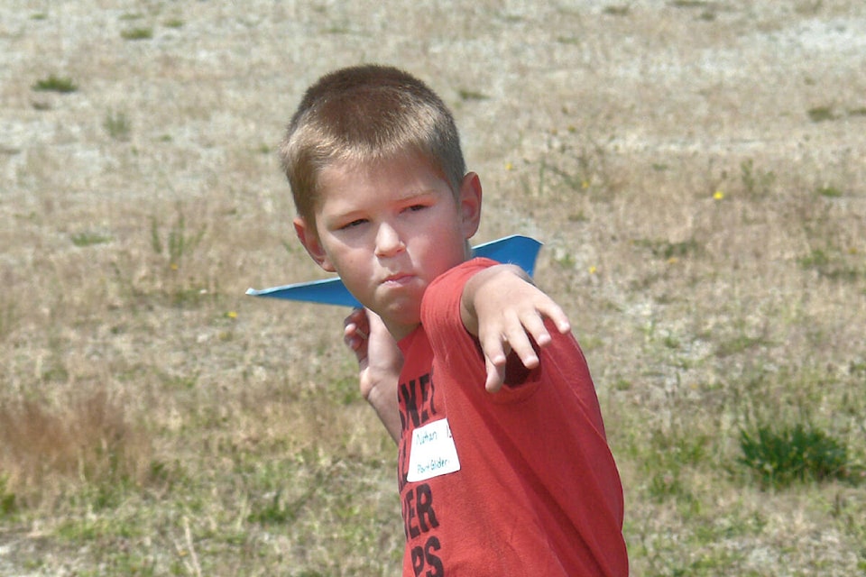 Nathan Struik, 8, from Clayton Heights winds up at the second Explore Science Club paper plane flying contest on Saturday, July 9, at Buckley Park in Langley City. 42 kids took part. (Dan Ferguson/Langley Advance Times)