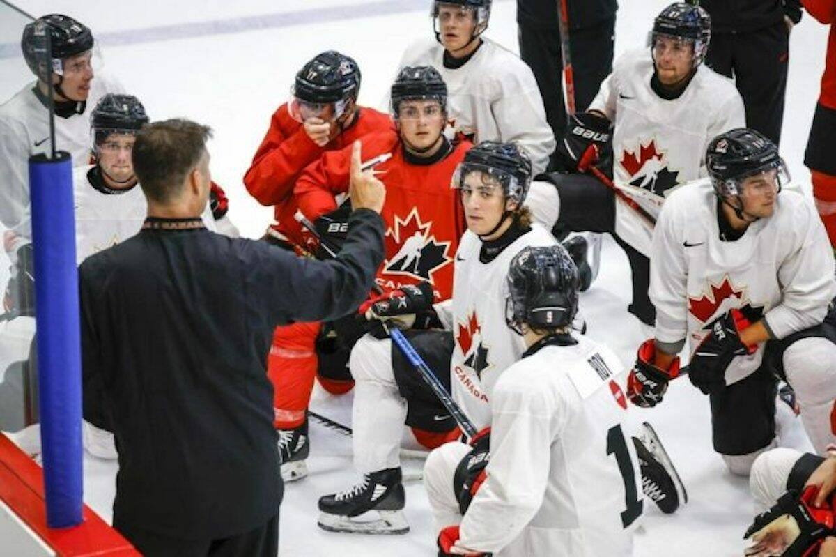 Canadas National Junior Team assistant coach Michael Dyck, left, gives instructions during training camp practice in Calgary, Tuesday, Aug. 2.THE CANADIAN PRESS/Jeff McIntosh