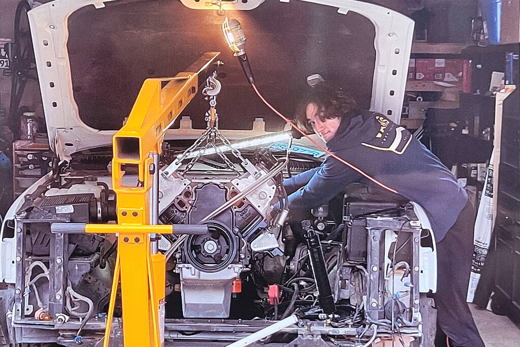 Brookswood resident Brodie Johnstone at work on installation of the 5.3 litre LS V8 that now powers his 1999 GMC Sierra 1500. (Special to Langley Advance Times)