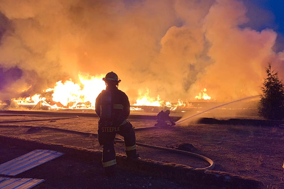 A 91ԭ Township firefighter at the fire that destroyed a Brookswood barn early Monday, Sept. 12. (91ԭ Township Fire Department/Special to the 91ԭ Advance Times)