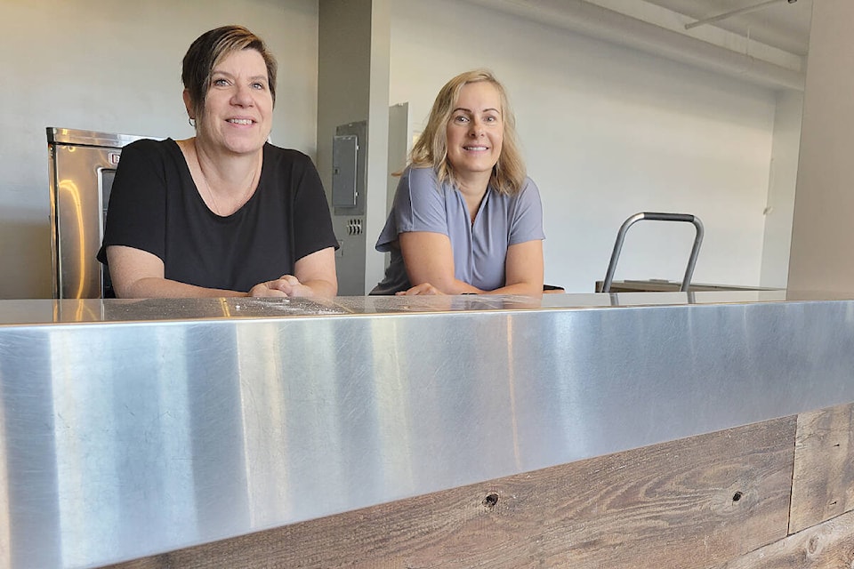 In September, Langley Meals On Wheels Services Society Program Manager Barb Stack and Executive Director Shannon Woykin, had their picture taken at the under-construction coffee bar in the Aldergrove Community Station House kitchen in the 2900-block of 272nd Street, home of the charity’s planned cafe. In October, Woykin revealed an ‘unexpected delay’ was holding up completion. (Dan Ferguson/Langley Advance Times)