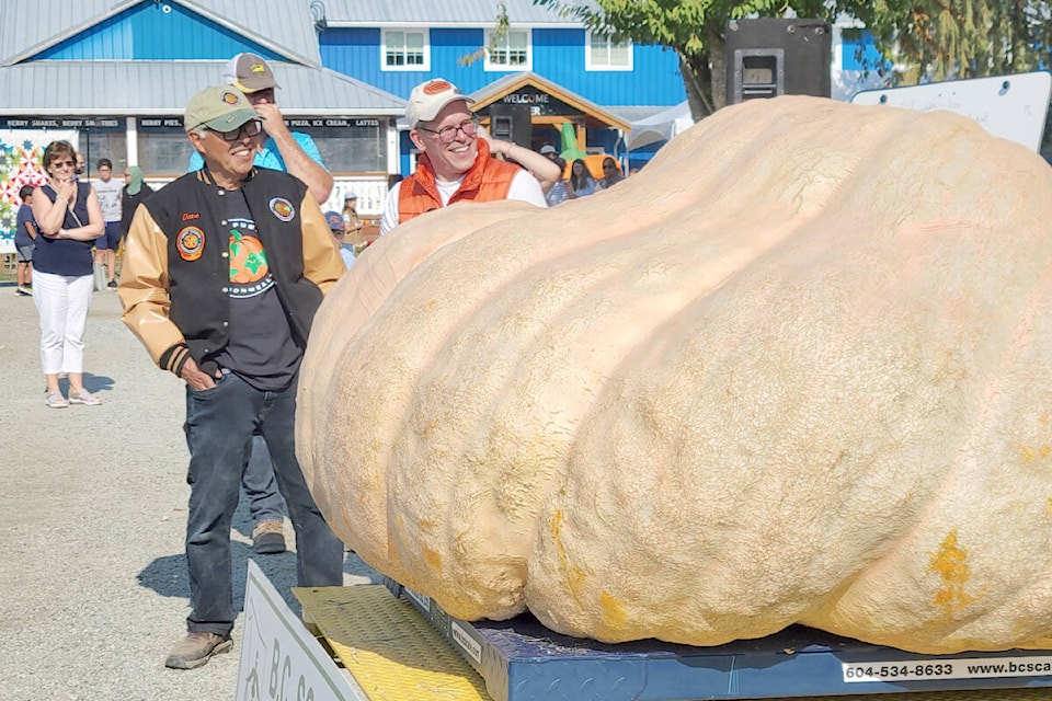 Richmond’s Dave Chan (left) won the Giant Pumpkin Weigh-Off on Saturday, Oct. 8 with this 1,676 lb. behemoth. The returning B.C. record holder had been hoping to break 2,000 lbs. (Dan Ferguson/Langley Advance Times)
