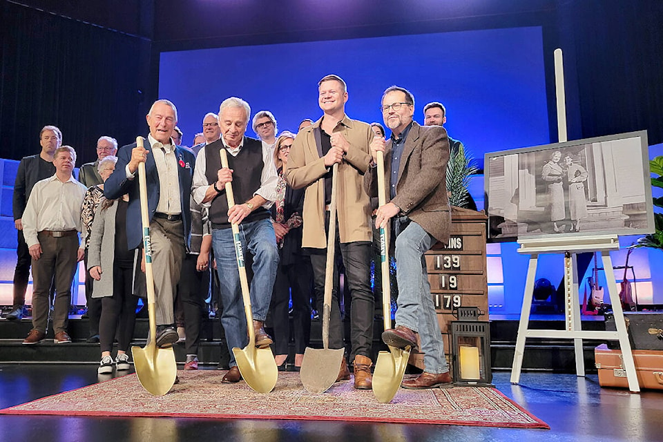 Due to heavy rain and wind, the Oct. 30 dedication ceremony for the Christian Life Assembly’s new housing project was moved indoors at the Langley church. It will be named ‘Jennie Gaglardi Place.’ Front row (left to right) Peter Fassbender, president of the CLA Housing Society, Bob Gaglardi (Jennie’s son), Ian Martens, chair of the church building committee, with a shovel used at a previous sod-turning for the church, and CLA lead pastor Derrick Hamre. (Dan Ferguson/Langley Advance Times)