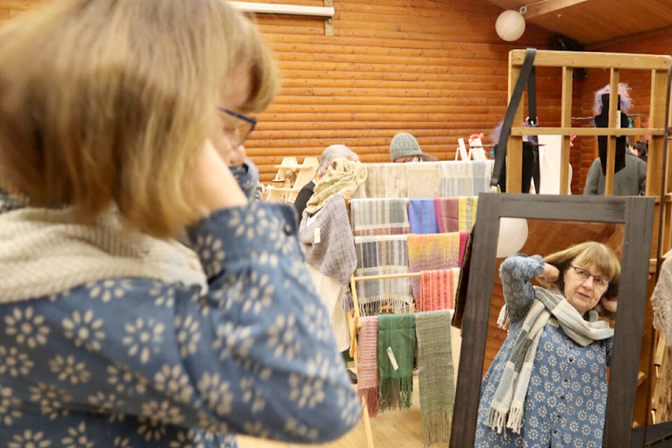 Pat Wrigley is a member of the 52-year-old Langley Weavers’ and Spinners’ Guild. She checked out a scarf at the 2022 show. (Langley Advance Times files)