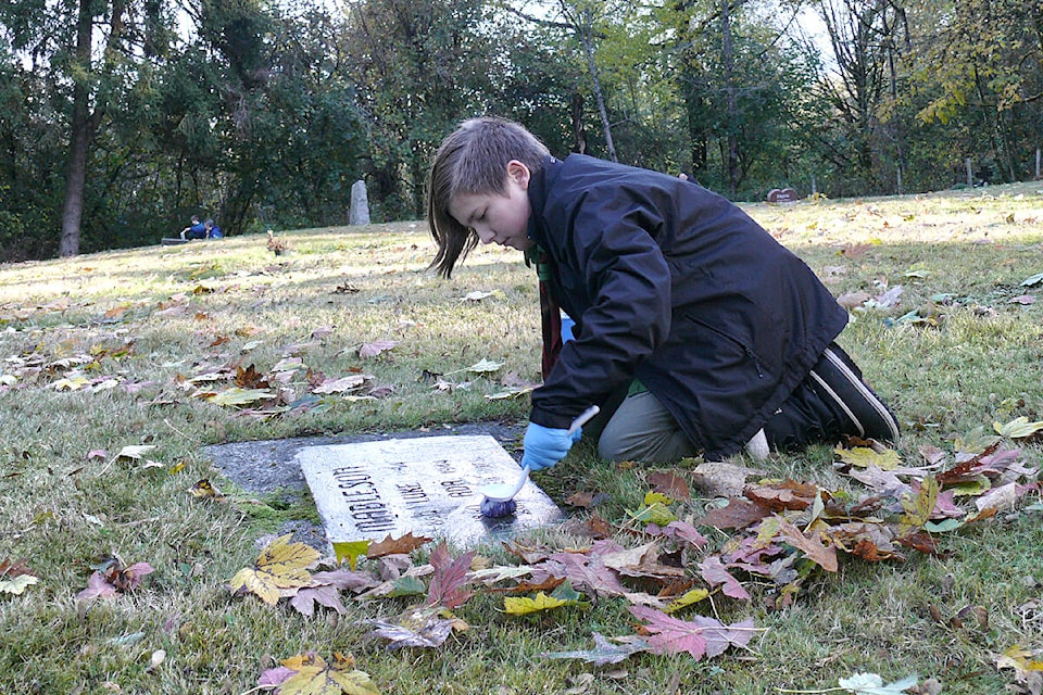 Lucas Parks took part in the annual cleaning of veterans headstones at the Murrayville cemetery on Saturday, Nov. 5, to prepare for Remembrance Day, saying he thought it was a nice thing to do. (Dan Ferguson/Langley Advance Times)
