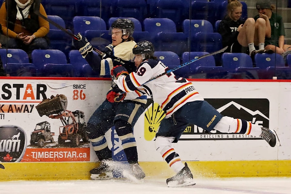 Vernon Vipers forward Isaac Tremblay (right) takes Langley forward Keeton Oakley into the boards during the Vipers’ 4-0 BCHL win over the Rivermen Saturday, Nov. 26, at Kal Tire Place. (Lisa Mazurek - Vernon Vipers Photography)