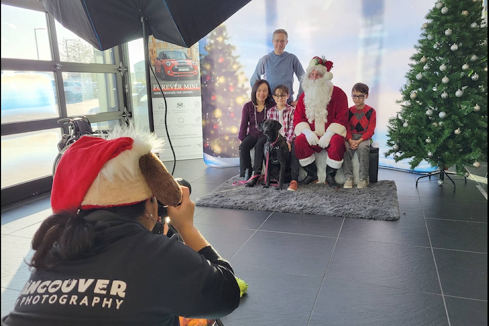Maddy, a one-year-old lab cross from Cloverdale, bought the whole family to Langley for a photo with Santa on Sunday, Nov. 27. Hosted by the OpenRoad Auto Group Mini dealership in Langley City, the event raised funds for the Langley Animal Protection Society. (Dan Ferguson/Langley Advance Times)