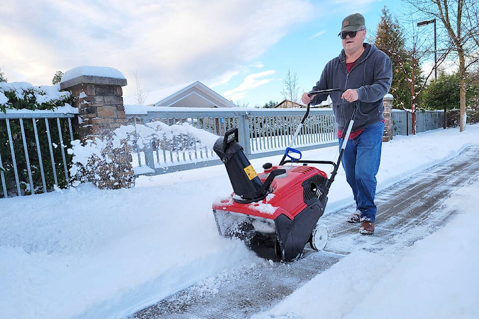 Art was out clearing snow off the sidewalk in front of Kingdom Hall in Aldergrove on Wednesday morning. “I’m a volunteer ” he explained. “After this I’m going home to clear my drive.” (Dan Ferguson/Langley Advance Times)