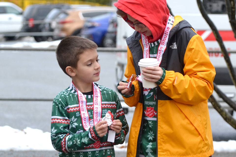 Siblings Lorenzo and Sebastian Armellini showing off their medals to each other. The duo participated in Salvation Army’s Santa Shuffle – a five km run event to raise money for Willows Family Life Centre. (Tanmay Ahluwalia/Langley Advance Times)
