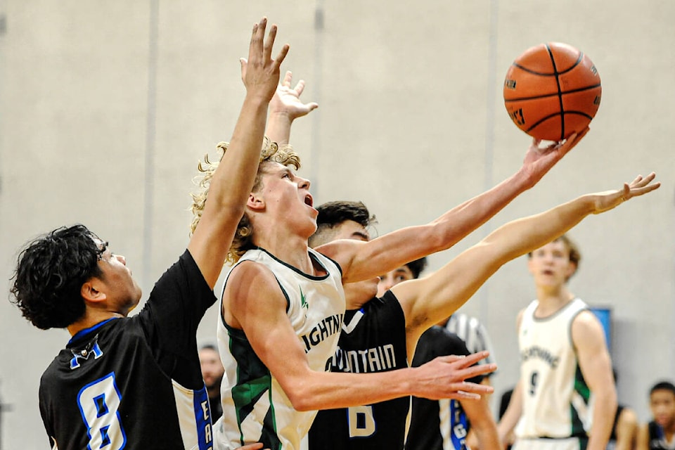 Willem Van Huizen (above) got the ball for Langley Christian Lightning. MVP Braedon Wager took a shot (right). Elijah Olson snagged the ball (below). The Lightning struck quickly and often against R.E. Mountain Eagles in the championship final of Draw 3 at the Tsumura Invitational. LCS went on to win 72-64. (Langley Events Centre)