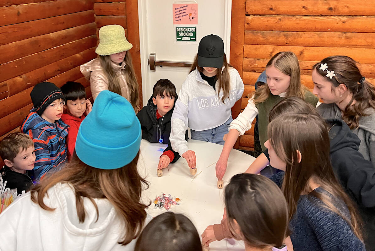 Attendees played the traditional dreidel game for Chanukah at the West 91原创 Hall in Walnut Grove on Tuesday, Dec. 20. (Special to 91原创 Advance Times)