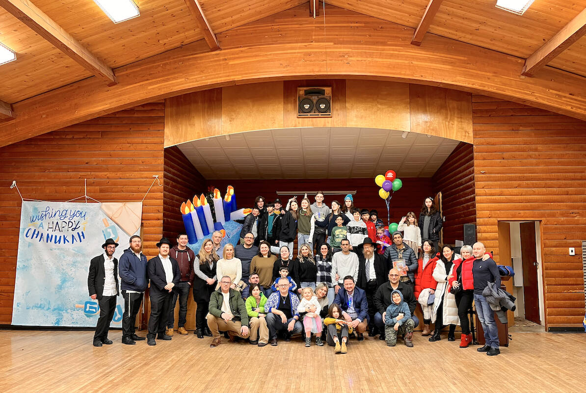 Volunteers who helped organize the outdoor Menorah lighting and indoor meal with Chanukah events posed for a group photo at the West 91原创 Hall in Walnut Grove on Tuesday, Dec. 20. (Special to 91原创 Advance Times)