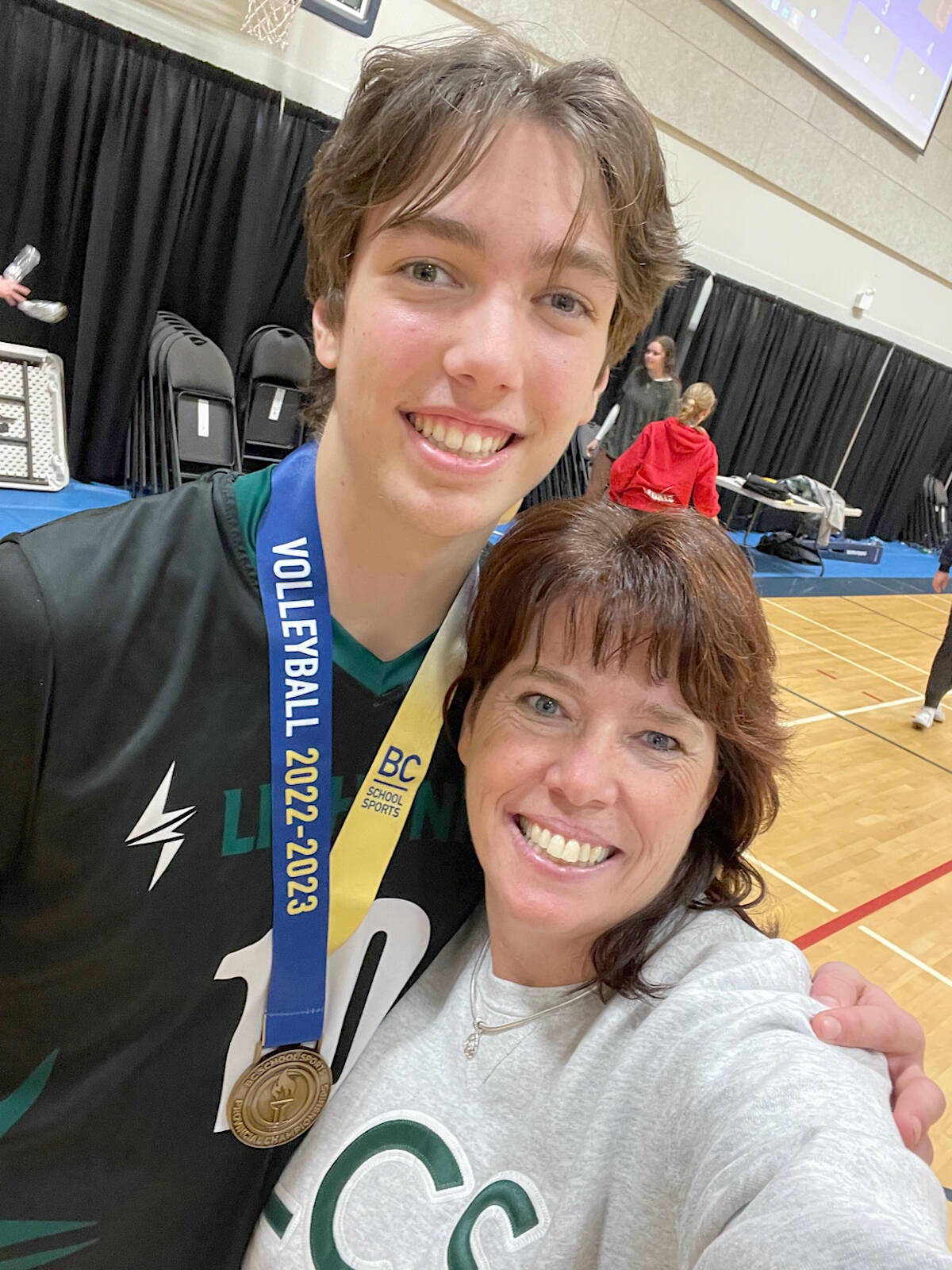 A proud Carole Hofer took a selfie with son Zach and his latest gold medal. Zach will be the third Hofer son to play for Trinity Western University, where Carol and husband Ryan have been coaching for more than two decades. (Special to Langley Advance Times)