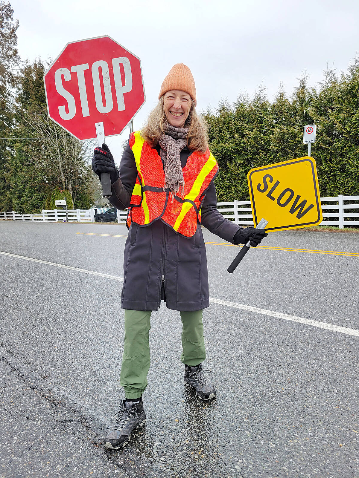 One of the traffic marshals showed off her traffic signs before the annual Wix-Brown Circuit Race got underway Saturday, March 11 beginning and ending at Wix-Brown school.(Dan Ferguson/黑马磁力)