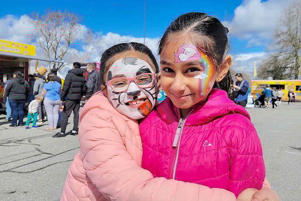 Ariyanna,6 (left) hugged Shayanna, 8 after a visit to the face-painting tent on Saturday, April 1. The sisters, from Walnut Grove, were among an estimated 19,000 who attended the second annual Food Truck Wars, held at KPU in 91ԭ March 31-April 2. (Dan Ferguson/91ԭ Advance Times)