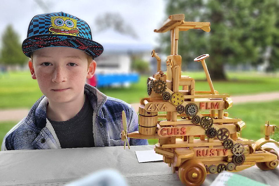 Byron Murray, 11, won an Earth Day up-cycling challenge at 91ԭ City’s Douglas Park on Saturday, April 22, with this combination boat, and car, composed of recycled parts. (Dan Ferguson/91ԭ Advance Times)