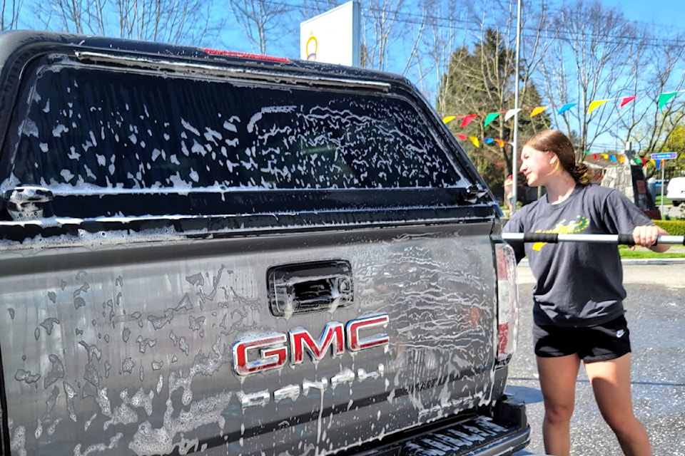 Ruby Bagnall, Grade 12 student, washed cars to raise funds for dry grad on Saturday, April 29. (Kyler Emerson/Langley Advance Times)