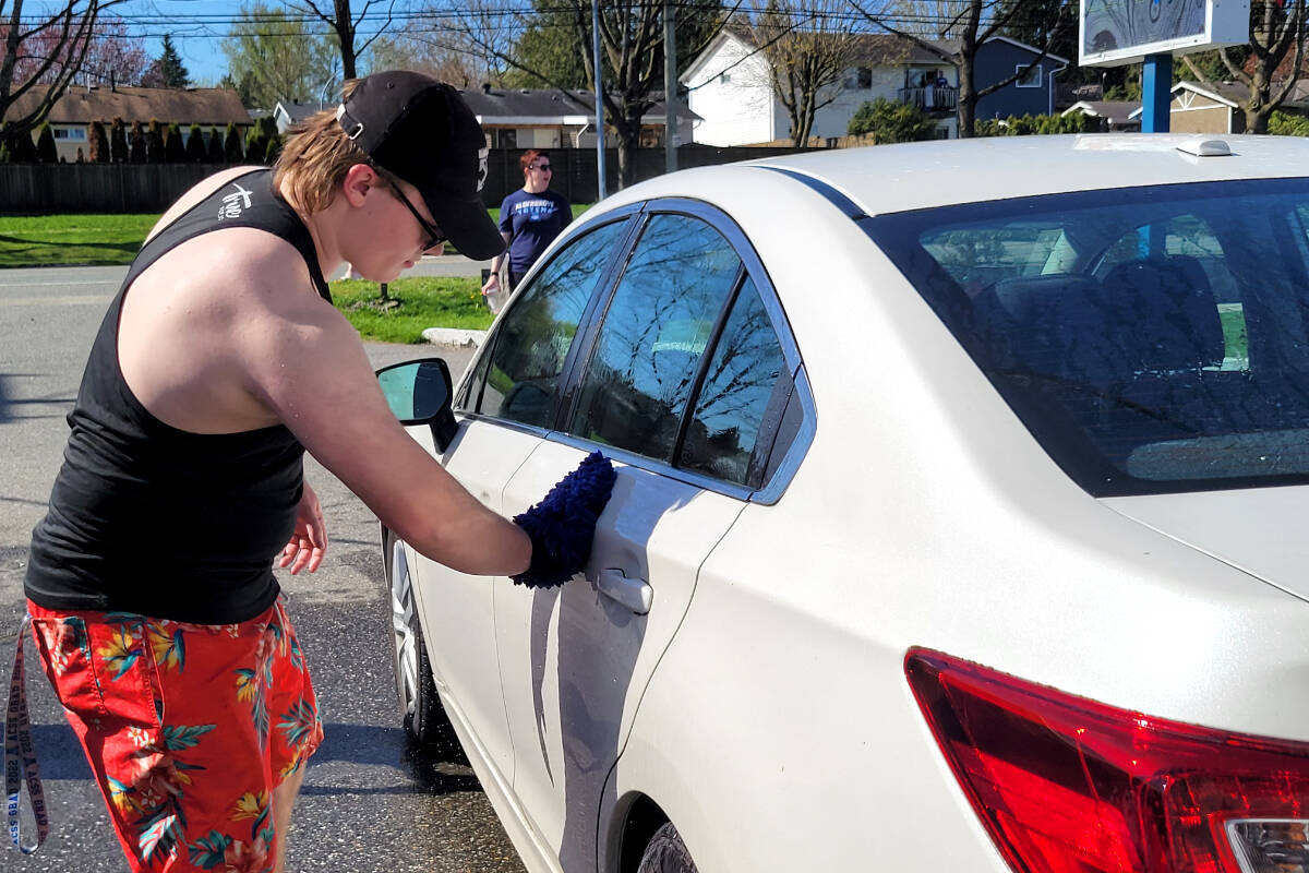 Students were hard at work washing cars for donations for their dry grad in the hot sun on Saturday, April 29. (Kyler Emerson/Langley Advance Times)