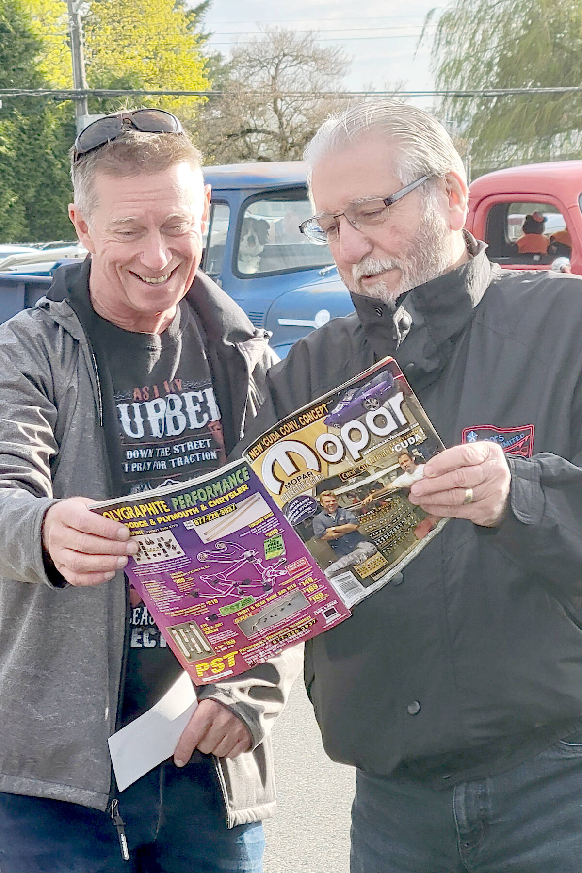 Two car fans checked out a magazine article at the ninth annual Country Car Show, held at the Aldergrove Community Secondary School on Sunday, April 30. (Dan Ferguson/Langley Advance Times)