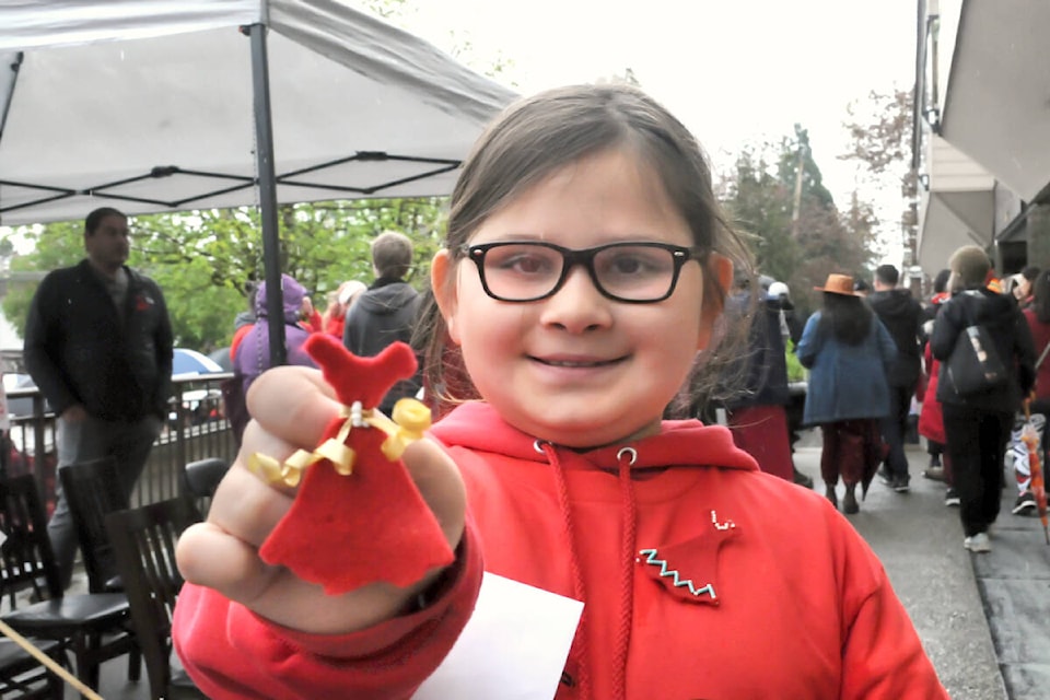 Red Dress Walk participants, such as Morgan Zasada, whose family orginally came from the Tsimshian people of the North Coast, shows a red felt dress lapel pin. The Lower Fraser Valley Aboriginal Society distributed the hand crafted pins to walk participants. (Heather Colpitts/Langley Advance Times)