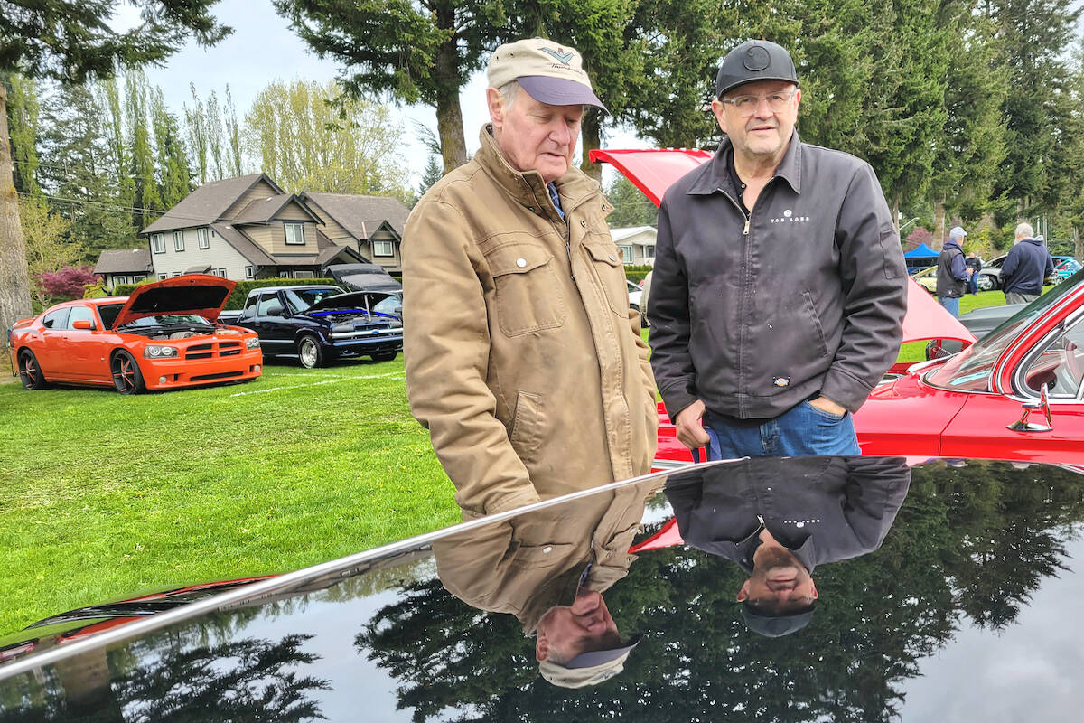 West Stinson (left) and Tom Hoeltgen (right) are reflected in the mirror-like paint finish of Hoeltgens just-restored 1973 De Tomaso Pantera. 500 cars and 2,000 car fans attended the 34th D.W. Poppy Secondary School car show fundraiser on Sunday, May 7. (Dan Ferguson/Langley Advance Times)