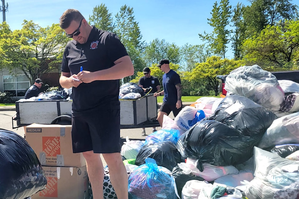 Zach Funk, director at Langley Township Firefighters Charitable Society, helped weigh clothing donations at the annual drive on Friday, May 12. (Kyler Emerson/Langley Advance Times)