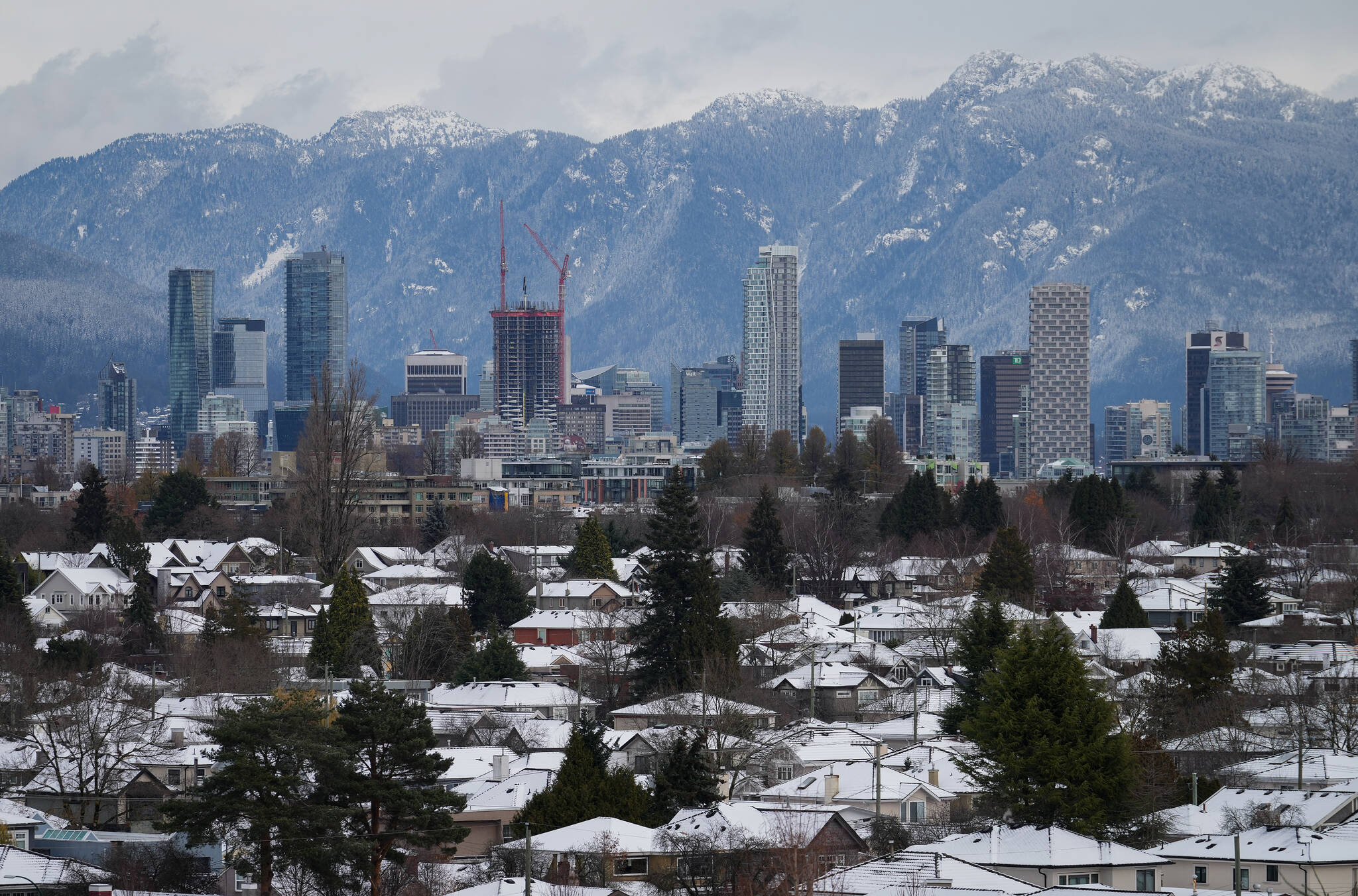 Snow-covered houses and the downtown skyline are seen after a snowstorm, in Vancouver, B.C., Nov. 30, 2022. (THE CANADIAN PRESS/Darryl Dyck)