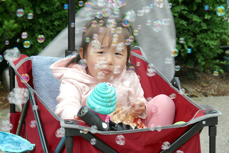 A bubble machine kept this young visitor amused. (Dan Ferguson/Langley Advance Times)
