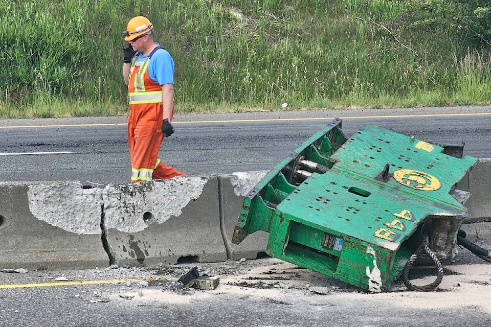 Highway #1 westbound at the 264th Street overpass in Aldergrove was closed for several hours Monday morning, May 29, after a flatbed semi truck failed to clear the overpass, knocking a piece of heavy equipment on to the road and damaging the trailer. Engineers determined the overpass was safe to use. (Dan Ferguson/Langley Advance Times)