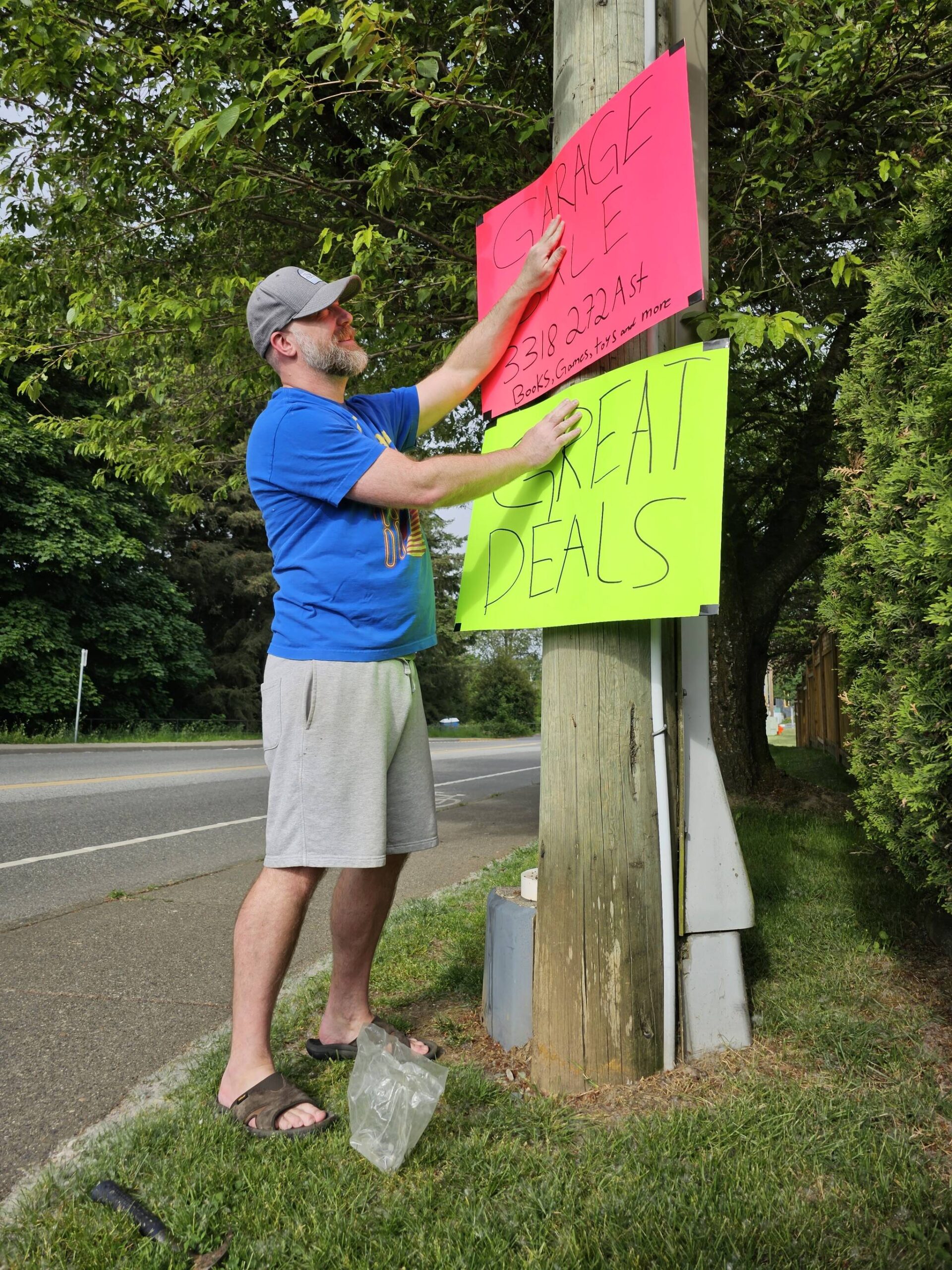 Aldergrove resident Ken Boulter was putting up signs at the turnoff to his garage sale on Saturday, May 27.(Dan Ferguson/Langley Advance Times)