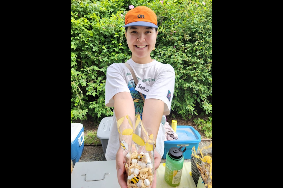 Volunteers gave out goodie bags with bee-themed snacks at the Festival of Bees on Saturday, May 27. (Kyler Emerson/Langley Advance Times)