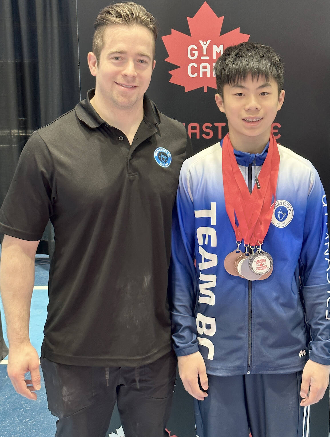 Langley Gymnastics Foundation coach Mark Rowbotham (L) and gymnast Ethan Lee at the 2023 Canadian National Championships held at Richmond Oval May 18-22. (LGF/Special to Langley Advance Times)